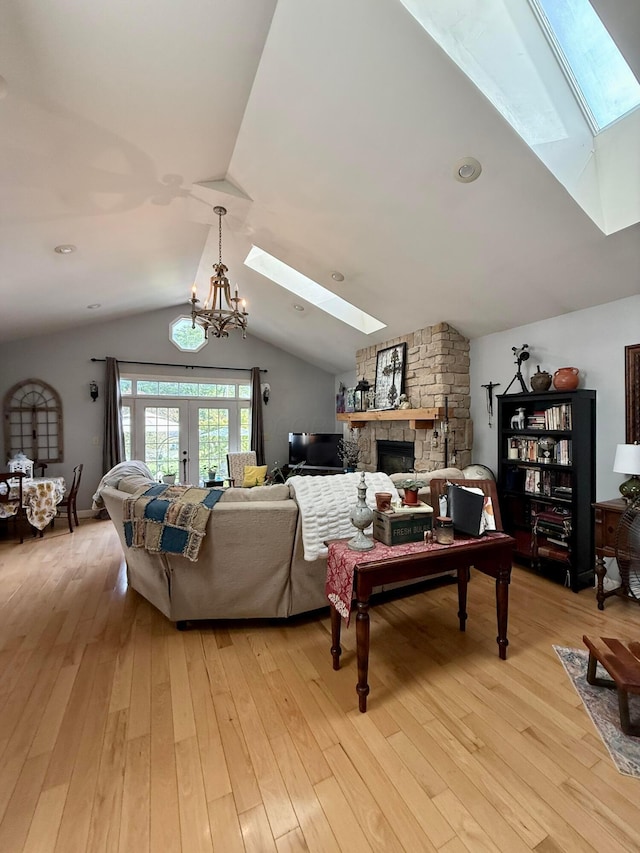 550 E Allen St, Lancaster, OH 43130 - living area with a skylight, light wood-type flooring, lofted ceiling, a stone fireplace, and french doors