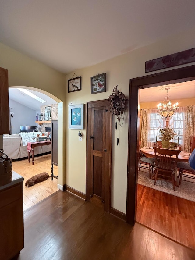 550 E Allen St, Lancaster, OH 43130 - foyer with hardwood / wood-style flooring, arched walkways, a chandelier, and baseboards