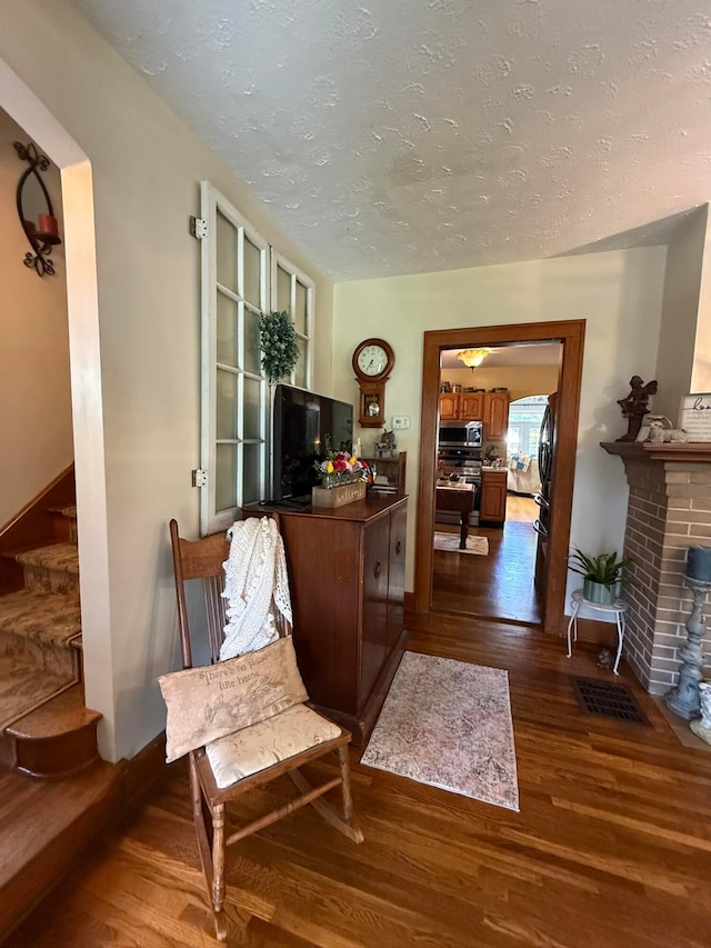 550 E Allen St, Lancaster, OH 43130 - living area featuring dark wood-type flooring, a textured ceiling, and a fireplace