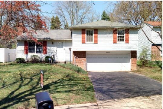 2630 Bella Via Ave, Columbus, OH 43231 - split level home featuring driveway, an attached garage, and brick siding