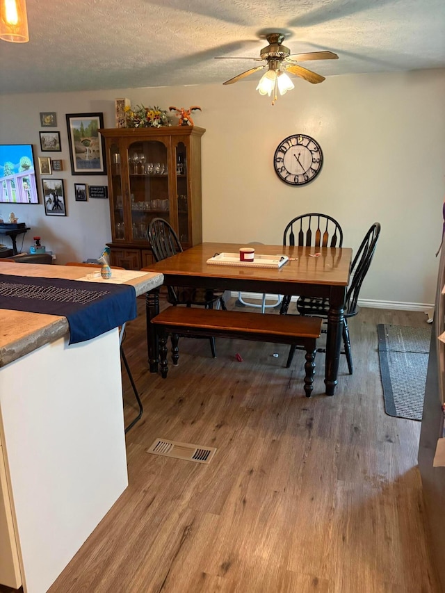 2630 Bella Via Ave, Columbus, OH 43231 - dining space featuring wood finished floors, a ceiling fan, and a textured ceiling