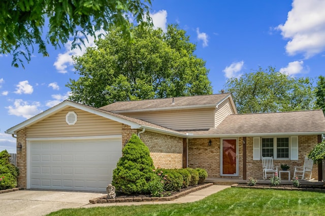 5690 Brinkley Ct, Columbus, OH 43235 - view of front facade with brick siding, a porch, a garage, concrete driveway, and a front yard