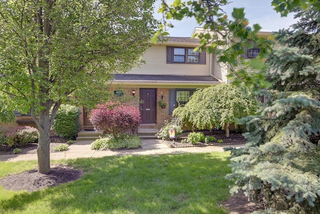 655 Providence Ave Unit 9-655J, Columbus, OH 43214 - view of property hidden behind natural elements with a front lawn and brick siding