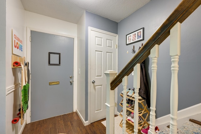 655 Providence Ave Unit 9-655J, Columbus, OH 43214 - entryway featuring dark wood-style floors, stairs, and a textured ceiling