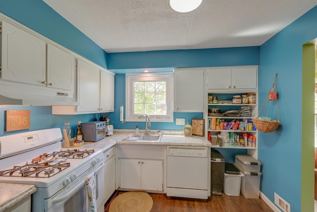 655 Providence Ave Unit 9-655J, Columbus, OH 43214 - kitchen featuring white appliances, a sink, under cabinet range hood, white cabinetry, and a textured ceiling