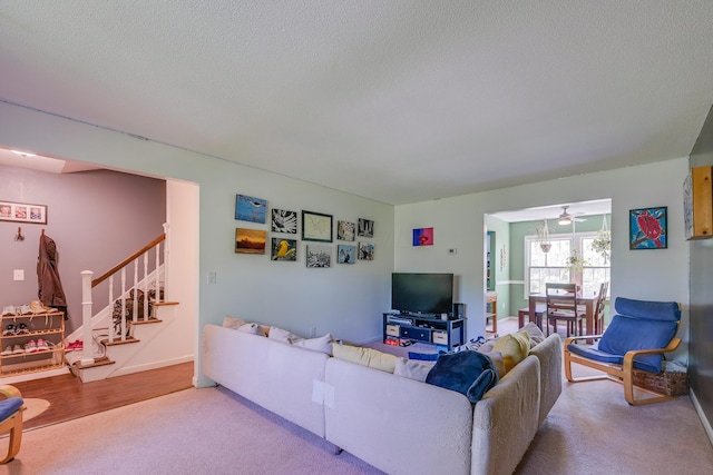 655 Providence Ave Unit 9-655J, Columbus, OH 43214 - living room with stairway, a textured ceiling, carpet floors, and a ceiling fan