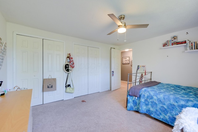 655 Providence Ave Unit 9-655J, Columbus, OH 43214 - bedroom featuring two closets, light carpet, and a ceiling fan