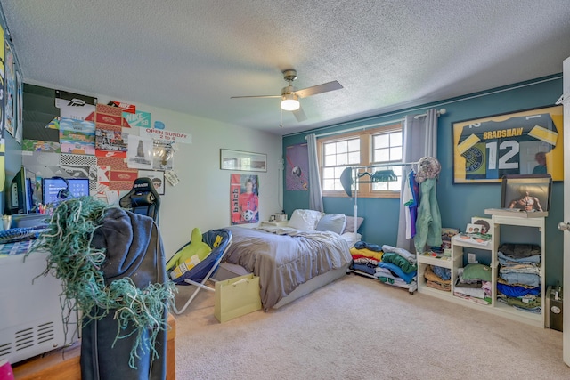 655 Providence Ave Unit 9-655J, Columbus, OH 43214 - bedroom featuring a textured ceiling, carpet flooring, and ceiling fan