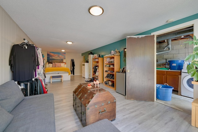 655 Providence Ave Unit 9-655J, Columbus, OH 43214 - living area with light wood-style flooring and washer / clothes dryer