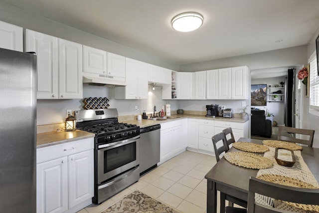 1015 Westview Dr, Hebron, OH 43025 - kitchen featuring appliances with stainless steel finishes, under cabinet range hood, light tile patterned floors, and white cabinets