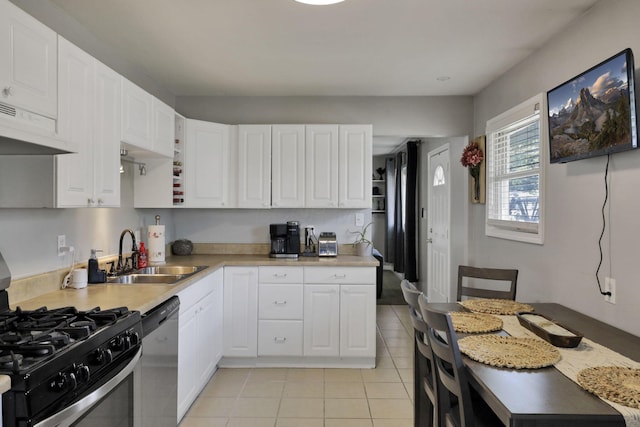 1015 Westview Dr, Hebron, OH 43025 - kitchen featuring stainless steel appliances, under cabinet range hood, white cabinetry, light countertops, and light tile patterned floors