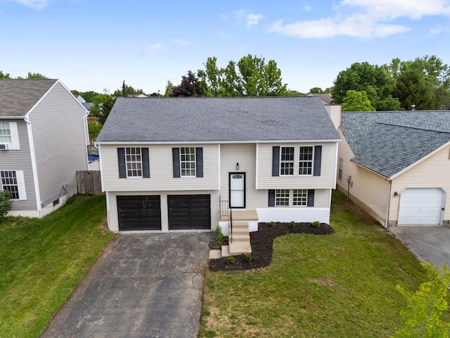 1047 Cherry Bud Dr, Columbus, OH 43228 - bi-level home with asphalt driveway, an attached garage, and roof with shingles