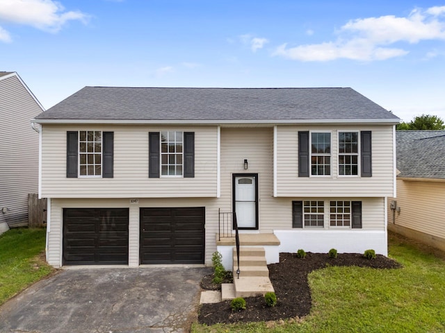 1047 Cherry Bud Dr, Columbus, OH 43228 - split foyer home with driveway, an attached garage, a front yard, and a shingled roof