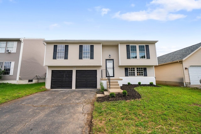 1047 Cherry Bud Dr, Columbus, OH 43228 - raised ranch featuring asphalt driveway, a front lawn, and a garage