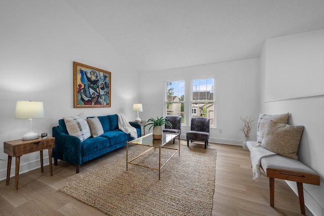1047 Cherry Bud Dr, Columbus, OH 43228 - living area featuring light wood finished floors, baseboards, and vaulted ceiling