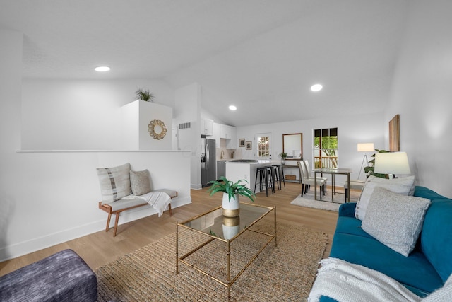 1047 Cherry Bud Dr, Columbus, OH 43228 - living room featuring baseboards, lofted ceiling, light wood-style floors, and recessed lighting