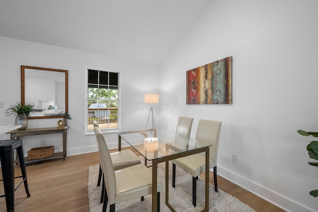 1047 Cherry Bud Dr, Columbus, OH 43228 - dining room featuring baseboards, wood finished floors, and lofted ceiling