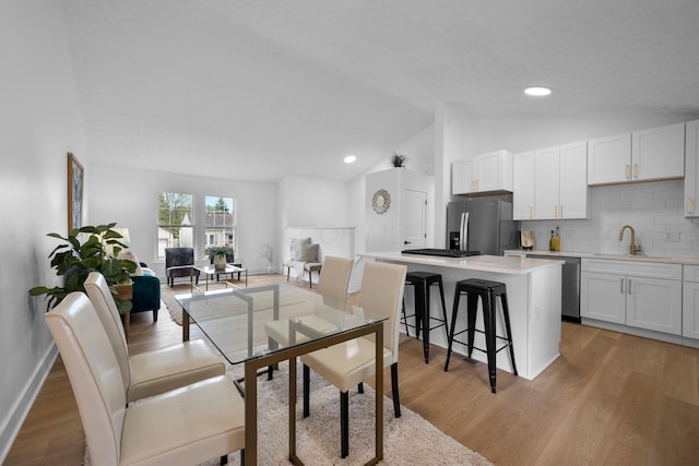 1047 Cherry Bud Dr, Columbus, OH 43228 - dining space featuring lofted ceiling, light wood-style flooring, baseboards, and recessed lighting