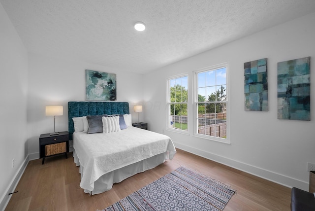 1047 Cherry Bud Dr, Columbus, OH 43228 - bedroom featuring baseboards, a textured ceiling, and wood finished floors