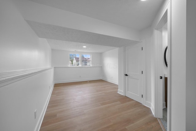 1047 Cherry Bud Dr, Columbus, OH 43228 - below grade area featuring light wood-style floors, baseboards, recessed lighting, and a textured ceiling