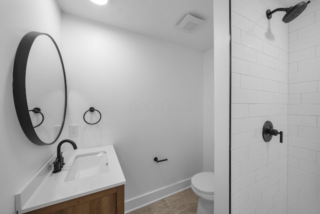 1047 Cherry Bud Dr, Columbus, OH 43228 - bathroom featuring vanity, tiled shower, toilet, and baseboards
