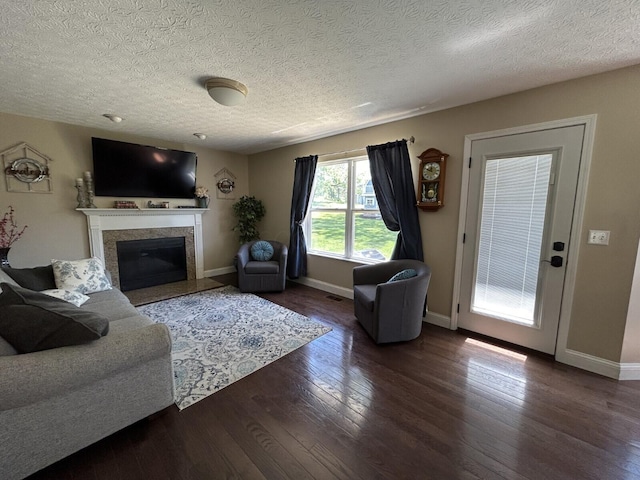5321 Longshadow Dr, Westerville, OH 43081 - living area featuring hardwood / wood-style floors, a premium fireplace, baseboards, and a textured ceiling