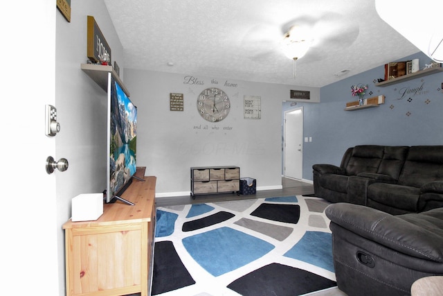 4037 Millview Ct, Columbus, OH 43207 - living room featuring a textured ceiling, wood finished floors, and baseboards