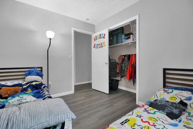 4037 Millview Ct, Columbus, OH 43207 - bedroom with wood finished floors, baseboards, a closet, and a textured ceiling