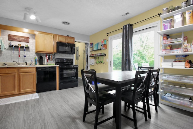 4037 Millview Ct, Columbus, OH 43207 - dining space with light wood-style floors and a textured ceiling