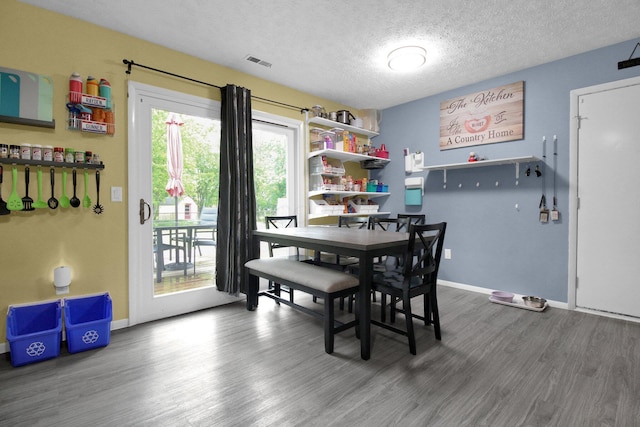 4037 Millview Ct, Columbus, OH 43207 - dining room with wood finished floors, baseboards, and a textured ceiling