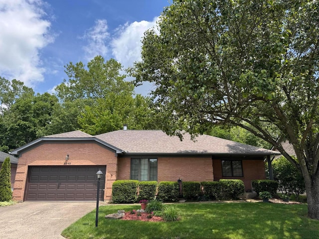 2049 Brandy Mill Ln, Dayton, OH 45459 - ranch-style home featuring brick siding, an attached garage, a front lawn, concrete driveway, and roof with shingles