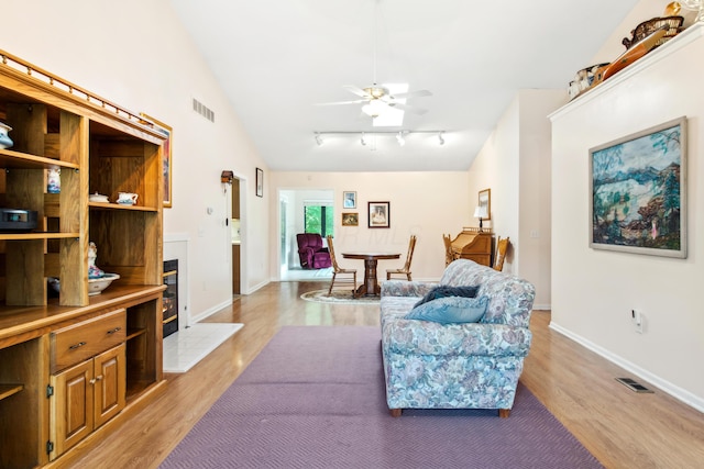 2049 Brandy Mill Ln, Dayton, OH 45459 - living area featuring light wood-type flooring, rail lighting, a ceiling fan, baseboards, and vaulted ceiling