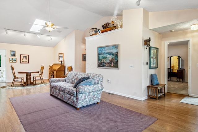 2049 Brandy Mill Ln, Dayton, OH 45459 - living area with rail lighting, wood finished floors, lofted ceiling, a ceiling fan, and baseboards