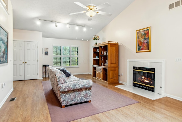 2049 Brandy Mill Ln, Dayton, OH 45459 - living area featuring light wood finished floors, a ceiling fan, a tile fireplace, track lighting, and baseboards