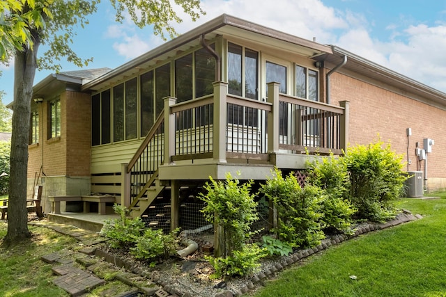 2049 Brandy Mill Ln, Dayton, OH 45459 - back of house with stairway, a sunroom, brick siding, and a deck