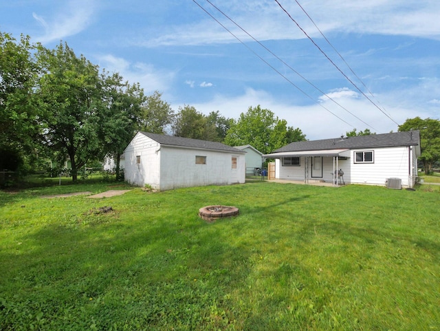 4702 Edinburgh Ln, Columbus, OH 43229 - view of green lawn featuring a fire pit, an outdoor structure, and central air condition unit