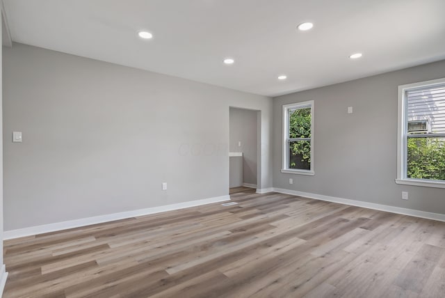341 Woodland Ave, Columbus, OH 43203 - spare room featuring baseboards, light wood finished floors, and recessed lighting