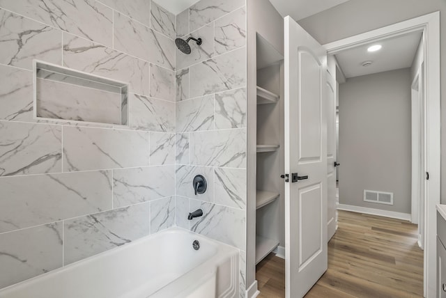 341 Woodland Ave, Columbus, OH 43203 - bathroom featuring shower / bath combination, wood finished floors, and baseboards
