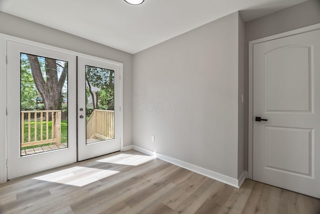 341 Woodland Ave, Columbus, OH 43203 - doorway to outside featuring light wood-type flooring and baseboards