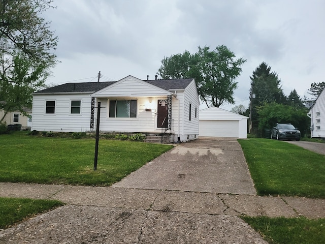 4530 Amesbury Rd, Columbus, OH 43227 - view of front of property with a front yard, an outbuilding, a detached garage, and a shingled roof