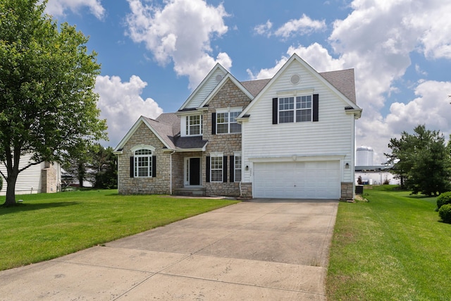 3899 Hampshire Ave, Powell, OH 43065 - view of front of property featuring stone siding, a garage, concrete driveway, and a front yard