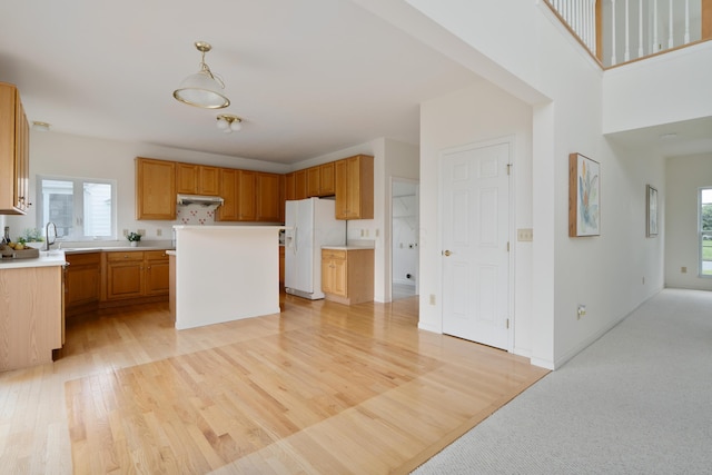 3899 Hampshire Ave, Powell, OH 43065 - kitchen featuring white fridge with ice dispenser, plenty of natural light, light wood-type flooring, and light countertops