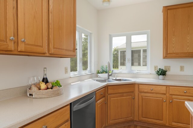 3899 Hampshire Ave, Powell, OH 43065 - kitchen featuring stainless steel dishwasher, a sink, light countertops, and brown cabinets
