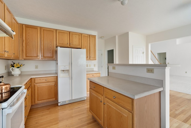 3899 Hampshire Ave, Powell, OH 43065 - kitchen featuring white appliances, light wood-style flooring, light countertops, and a center island
