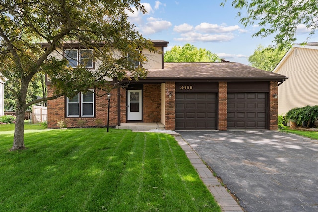 3456 Merrydawn Dr, Columbus, OH 43221 - view of front facade featuring a garage, asphalt driveway, a front lawn, and brick siding