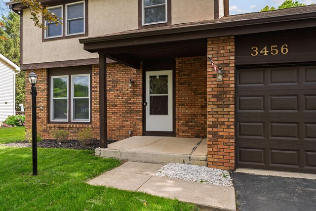 3456 Merrydawn Dr, Columbus, OH 43221 - entrance to property featuring brick siding, stucco siding, and a lawn