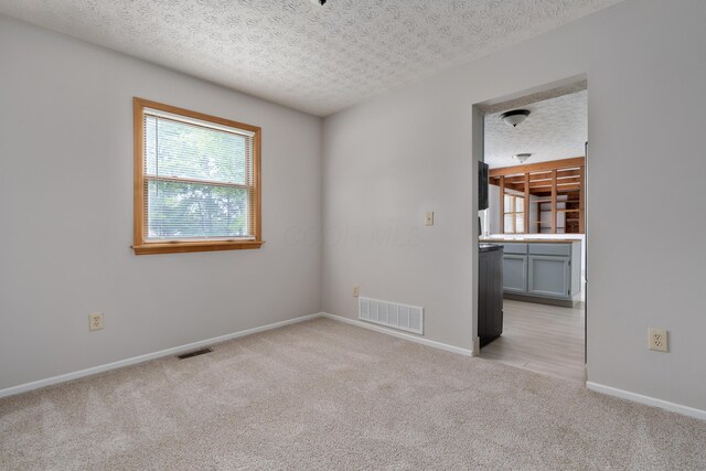 3456 Merrydawn Dr, Columbus, OH 43221 - unfurnished room featuring light carpet, a textured ceiling, and baseboards