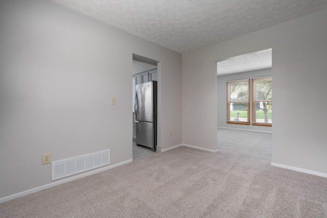 3456 Merrydawn Dr, Columbus, OH 43221 - spare room featuring light colored carpet, a textured ceiling, and baseboards