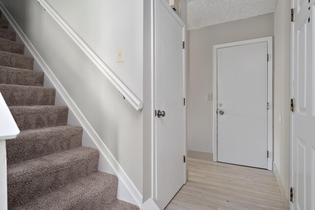 3456 Merrydawn Dr, Columbus, OH 43221 - staircase with wood finished floors and baseboards