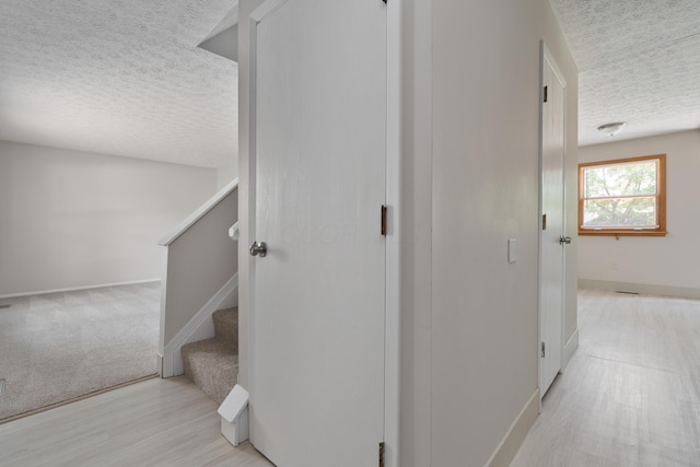3456 Merrydawn Dr, Columbus, OH 43221 - stairs with a textured ceiling, baseboards, wood finished floors, and carpet